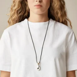 Metallic pendant necklace with leather cord
